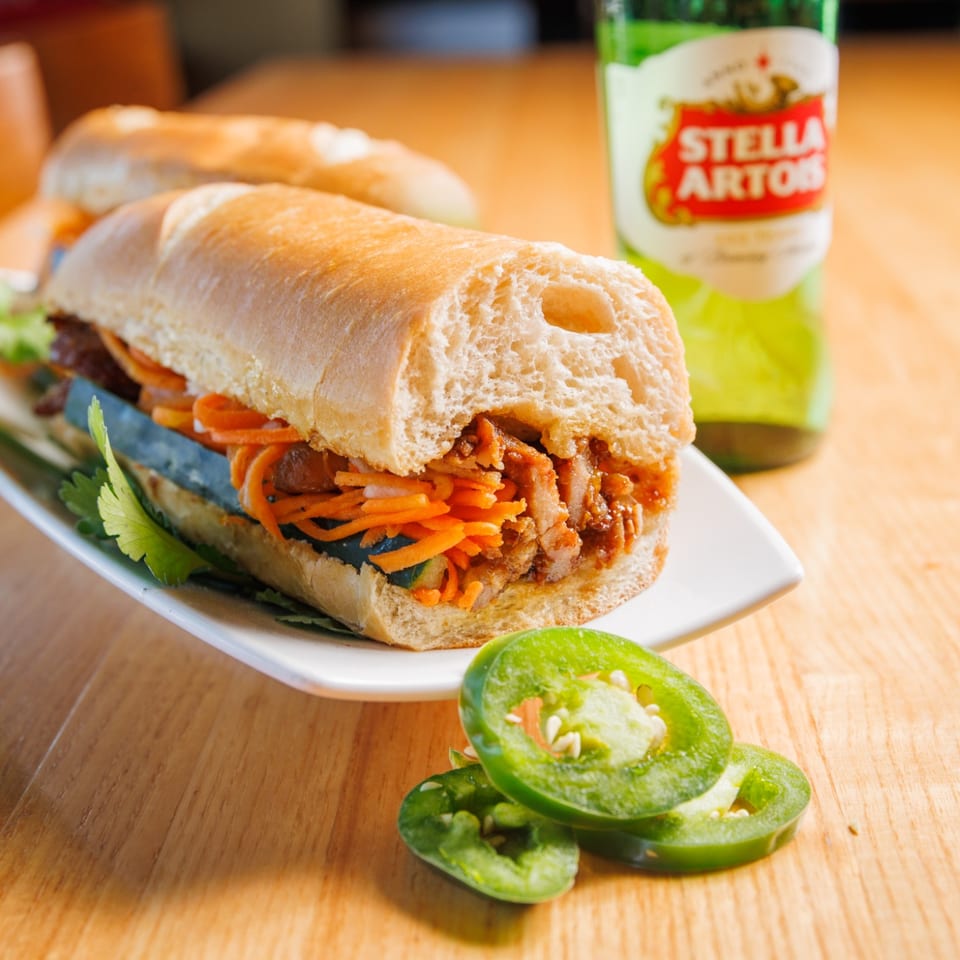 Grilled pork banh mi with pickled carrots, cucumber, and cilantro.